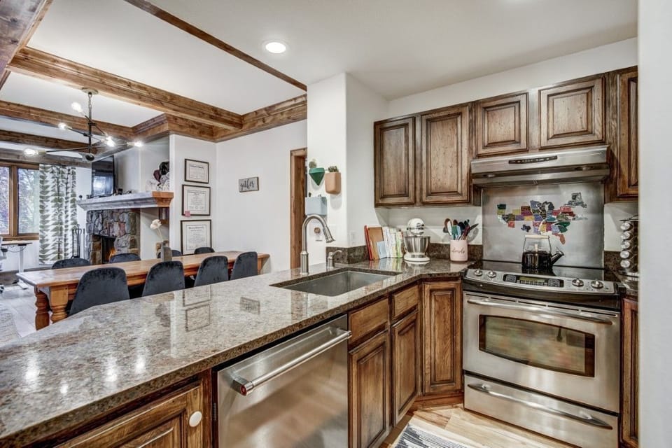 Warm wood finishes and thoughtful design come together in a kitchen made for easy meals and  conversations, just steps from all the comforts of home.