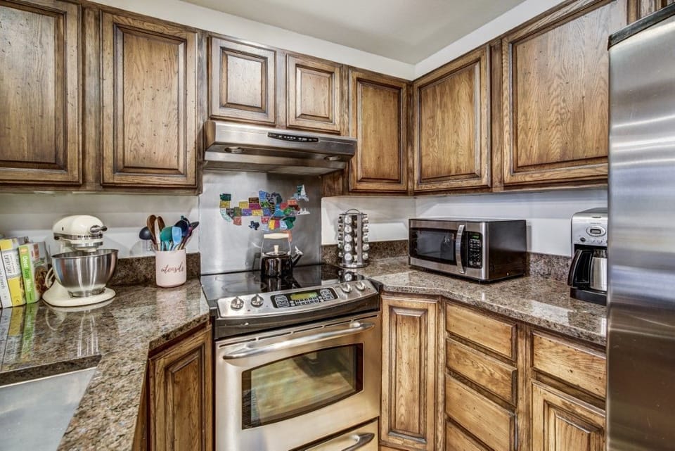 Rustic wood cabinetry and a thoughtful layout invite you to create meals and memories with ease in a functional kitchen.