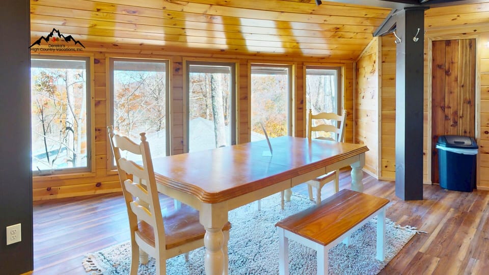 Gather around the spacious dining table surrounded by wall-to-wall windows overlooking the beautiful Sugar Mountain scenery.
