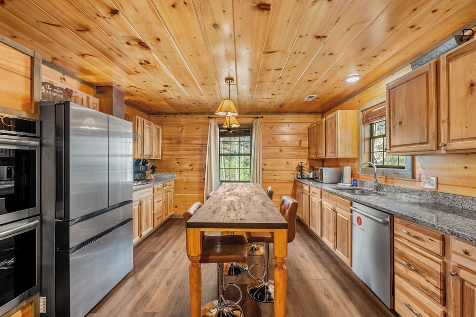 Spacious kitchen featuring stainless steel appliances and beautiful wood accents