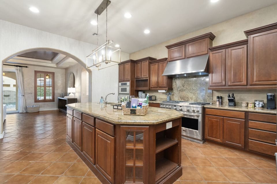 Spacious kitchen w/ ample counters, wood cabinetry & room to gather