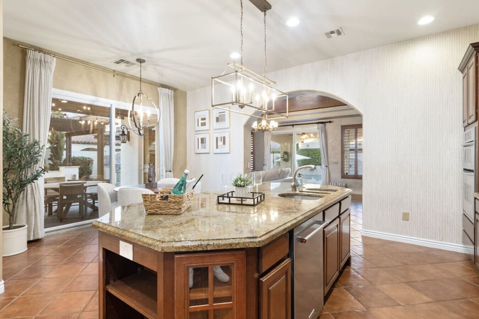 Spacious kitchen island w/ warm finishes, ideal for gathering & prep