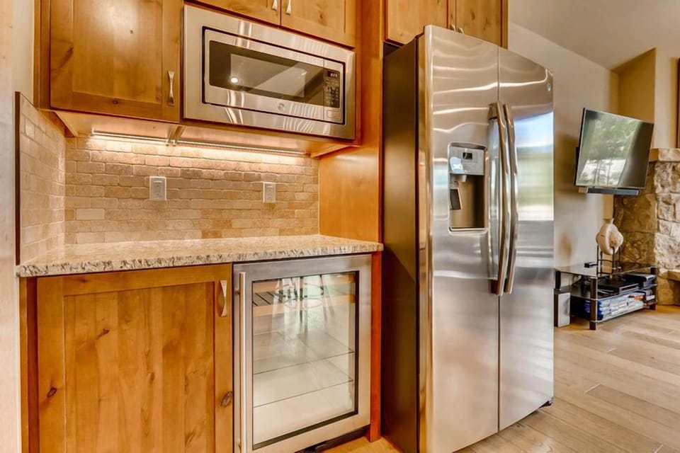 A touch of modern convenience — stainless steel appliances and a wine cooler elevate every culinary moment.