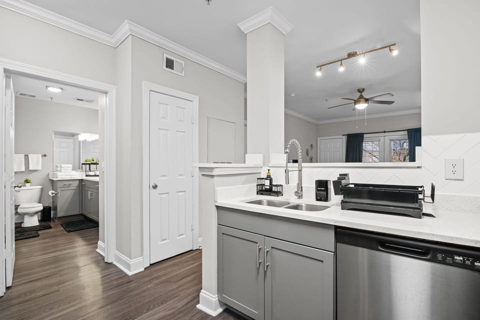 Open-concept layout with full kitchen, dishwasher & adjoining bath