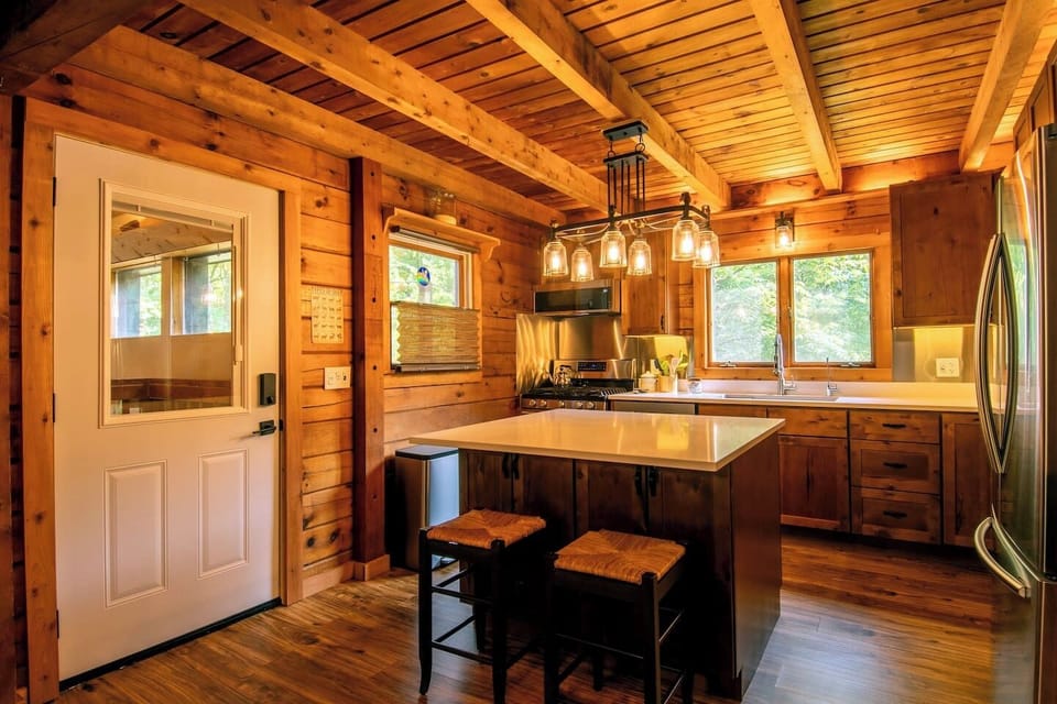Breakfast bar and door to sunroom (shared space). Extra cabinet space for your things under the island.