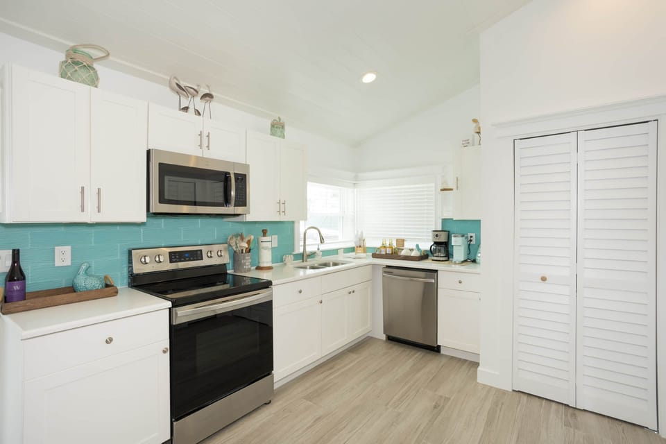 Stylish beachy kitchen with upgraded appliances for relaxed, family-friendly island living.