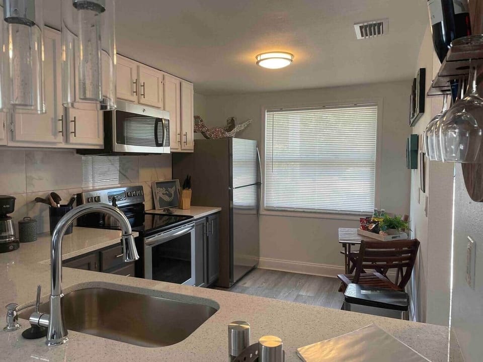 Modern kitchen with a cozy café table—perfect for coffee or casual meals.