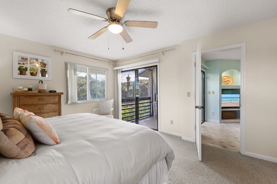 Wake up to sunshine and ocean vibes in this serene beachside bedroom. Features a comfy queen bed, private balcony, and breezy décor — perfect for a relaxing coastal getaway just steps from the shore.