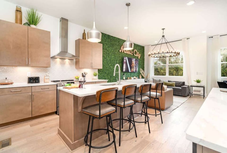 2nd Floor: Fully equipped kitchen, complete with stainless-steel appliances and a kitchen island with ample counter space and bar seating.
