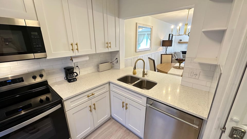 Kitchen fully equipped with appliances and utensils