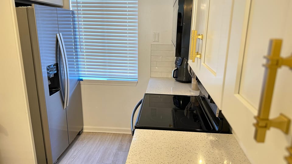 Kitchen fully equipped with appliances and utensils