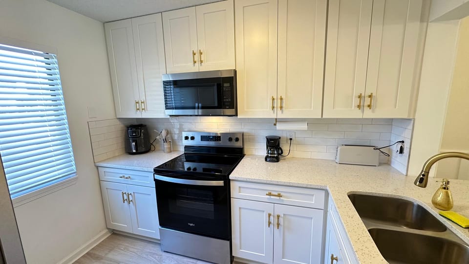 Kitchen fully equipped with appliances and utensils