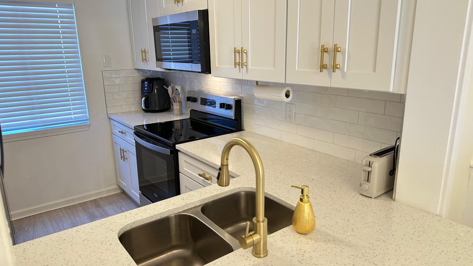 Kitchen fully equipped with appliances and utensils