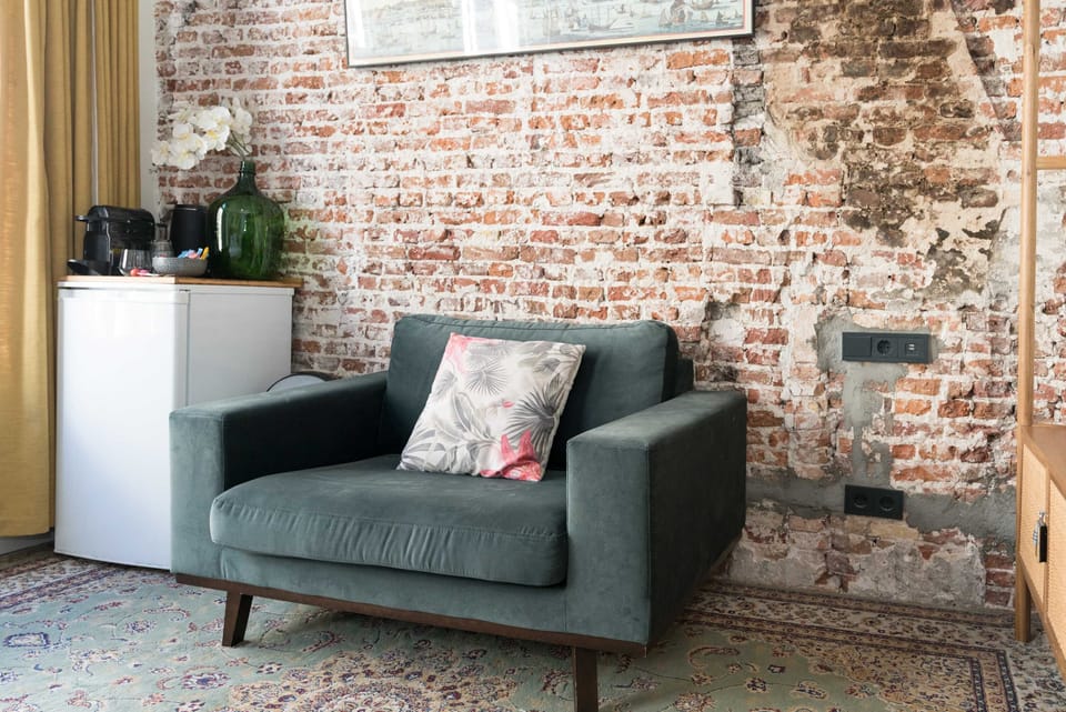 Urban charm: soft lighting and raw textures make this corner perfect for reading or relaxing.