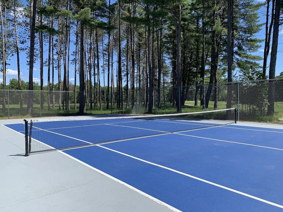 Play a sunny match on the crisp, well-kept tennis court.