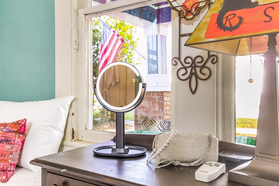 Light-filled workspace and vanity area with historic windows.  Lighted makeup mirrors, perfect for getting ready or catching up during your Pensacola visit. 