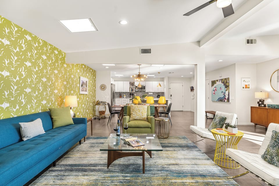 Open-concept living room with colorful modern furniture.