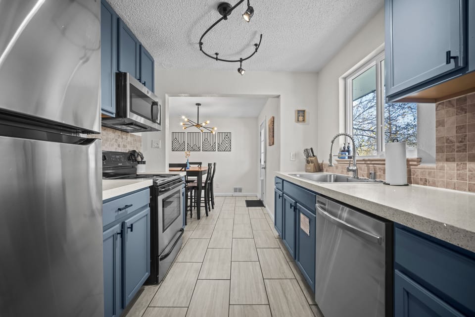 This clean, simple kitchen has everything you need—stovetop, oven, fridge, microwave, and a handy dishwasher.