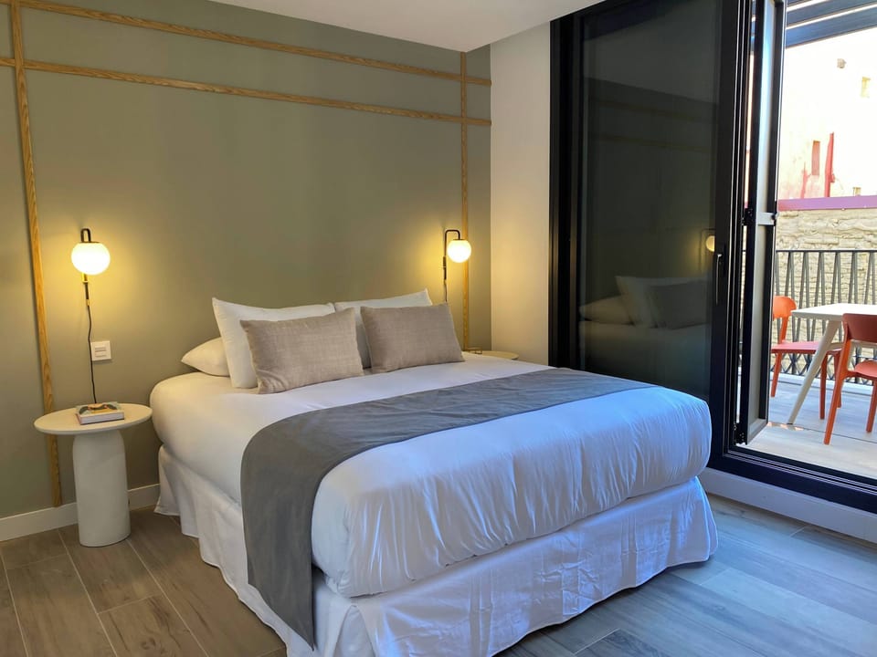 Bedroom with a simple bed and nightstand.