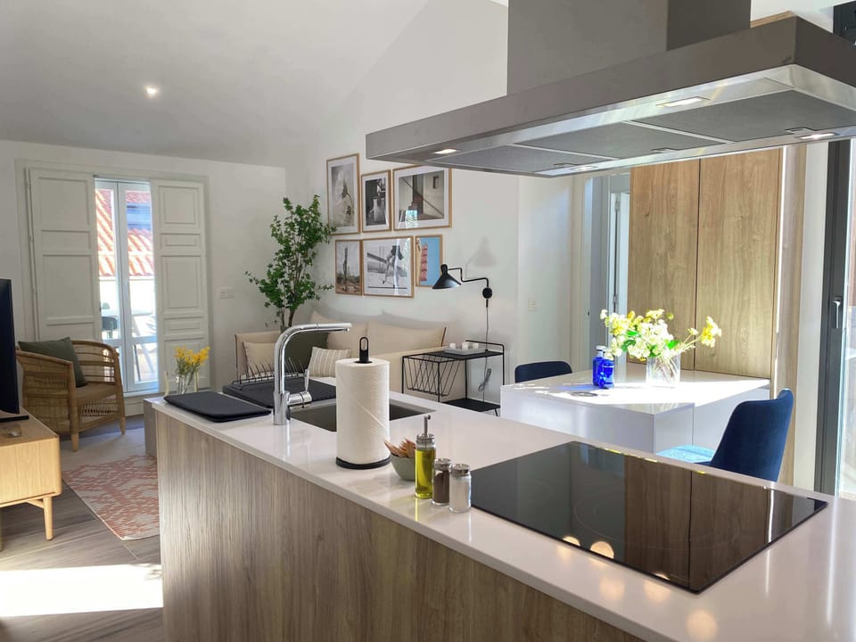 Another view of the modern kitchen island and the living area.
