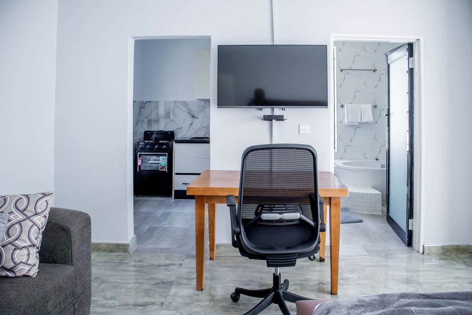 Family Suite, Garden View | In-room safe, desk, laptop workspace, iron/ironing board