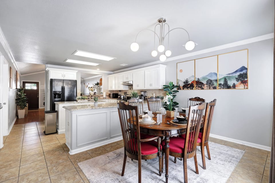 Spacious dining table that sits 6 with full tableware and silverware included.
