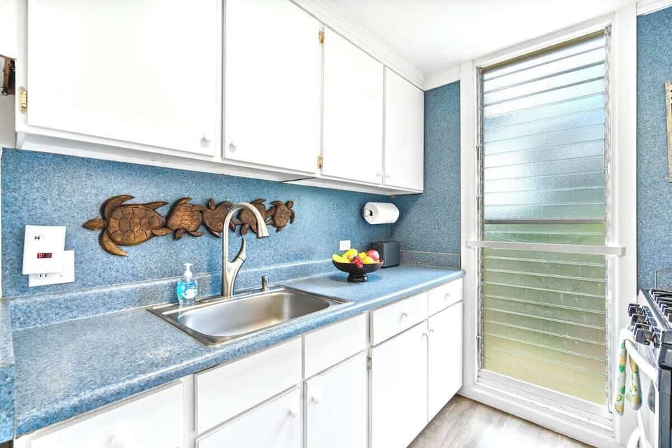Prepare your meals in this charming full kitchen featuring a fun sea turtle theme.