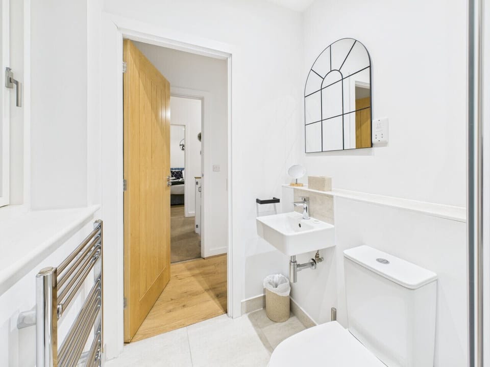 Clean and modern powder room, fully stocked with the essentials.
