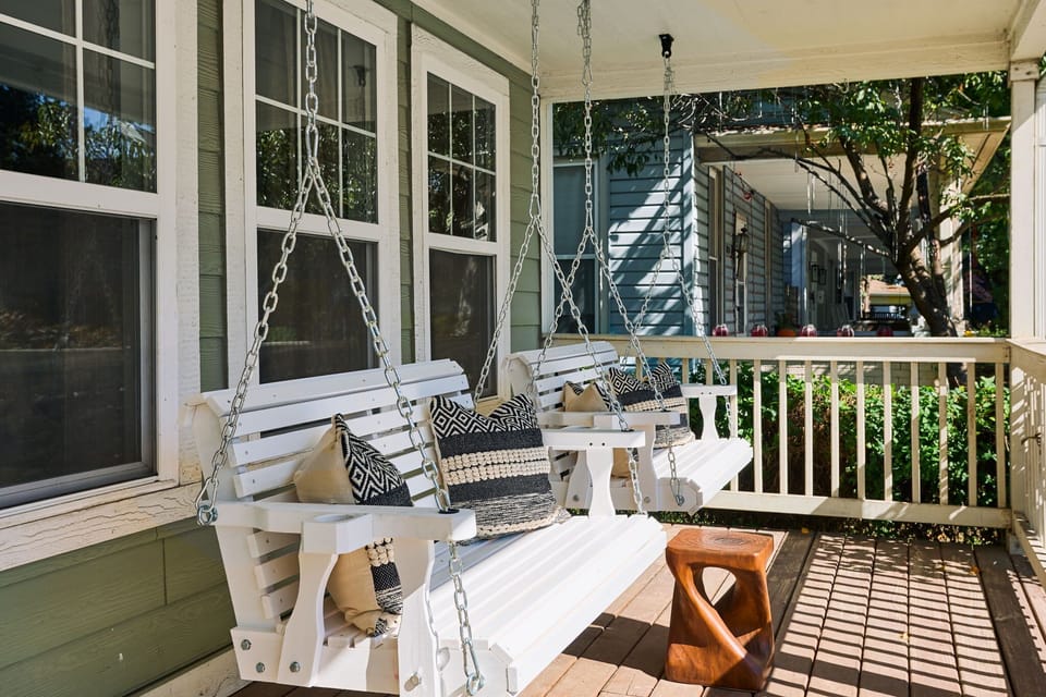 Front porch sittin’ made better with double swings and endless Indy charm.