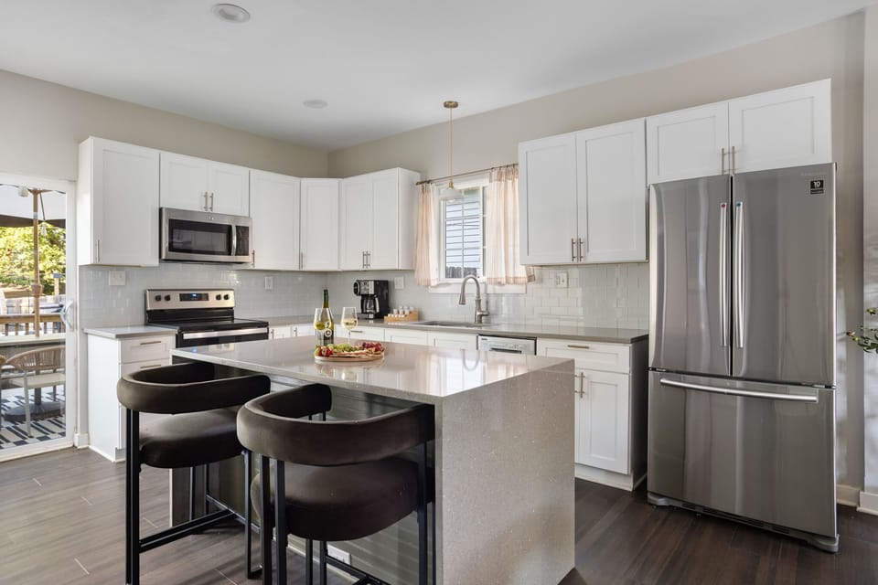 Gather around the island — your home base for coffee, cocktails, or dinner prep.