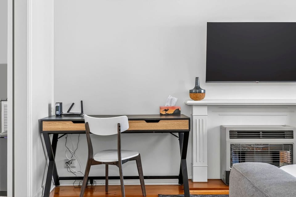 Bright living area with a practical study table, perfect for remote work, study, or planning your next adventure.
