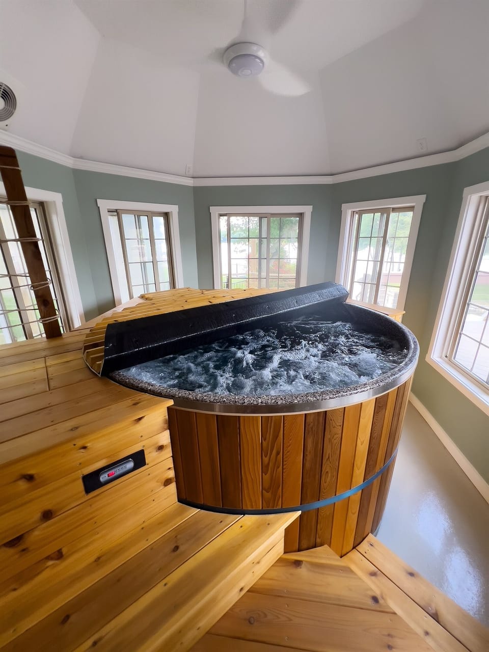 “Indoor cedar hot tub, steps from the living area.”
