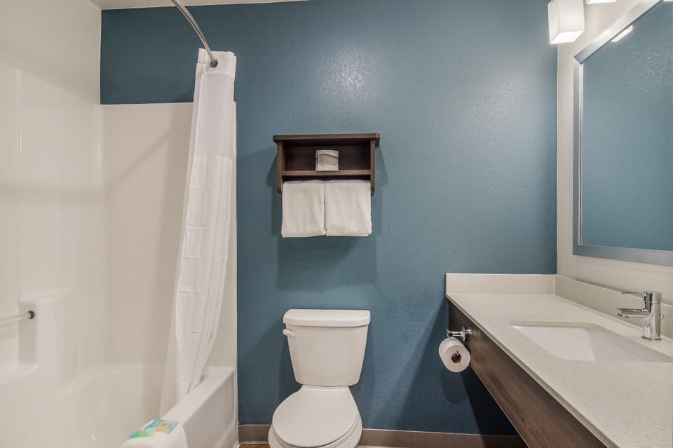 Refresh easily with a bright vanity and shower-tub combo.