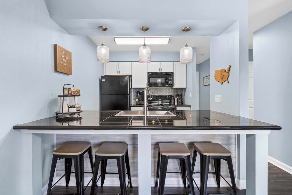 Sip morning coffee or grab a bite at the kitchen counter, with space for 4​