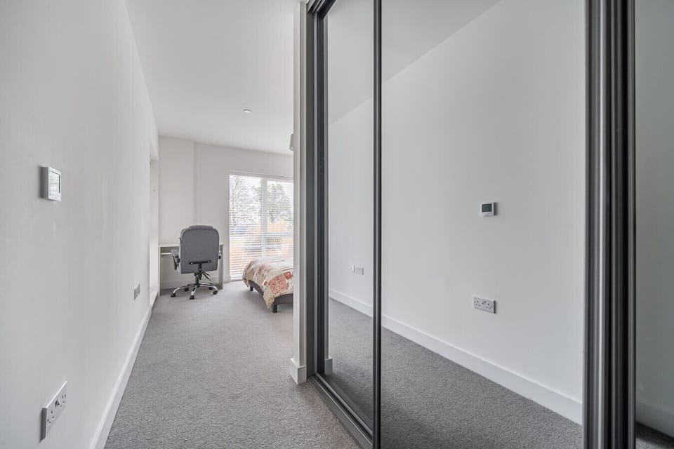 View from hallway into bedroom with workspace