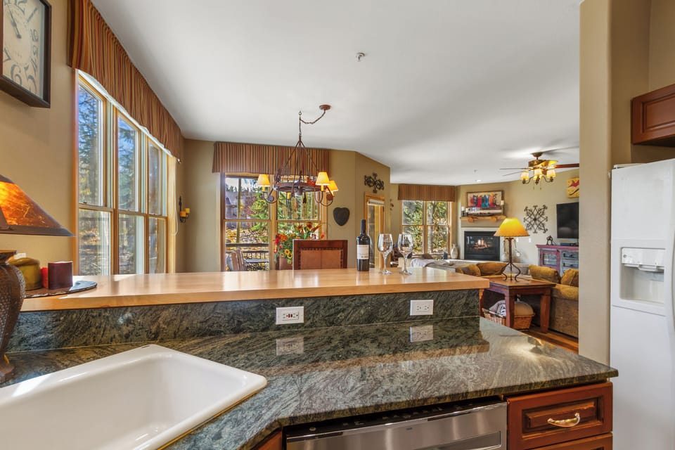Kitchen looks out to family and crew or aspen trees, mountains and dreams