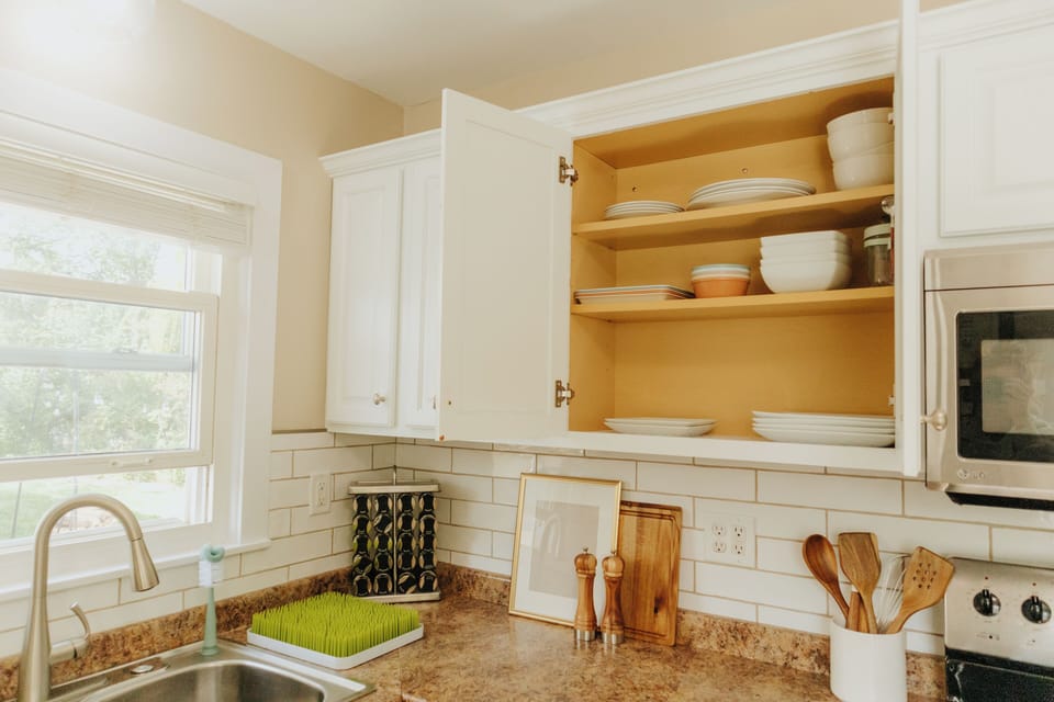 Modern kitchen stocked with cookware, dishware, and kid-friendly essentials.