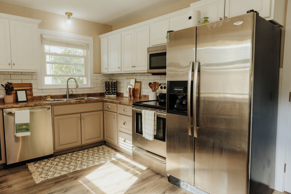 Full kitchen with modern appliances, cookware, and kid-friendly dishware.
