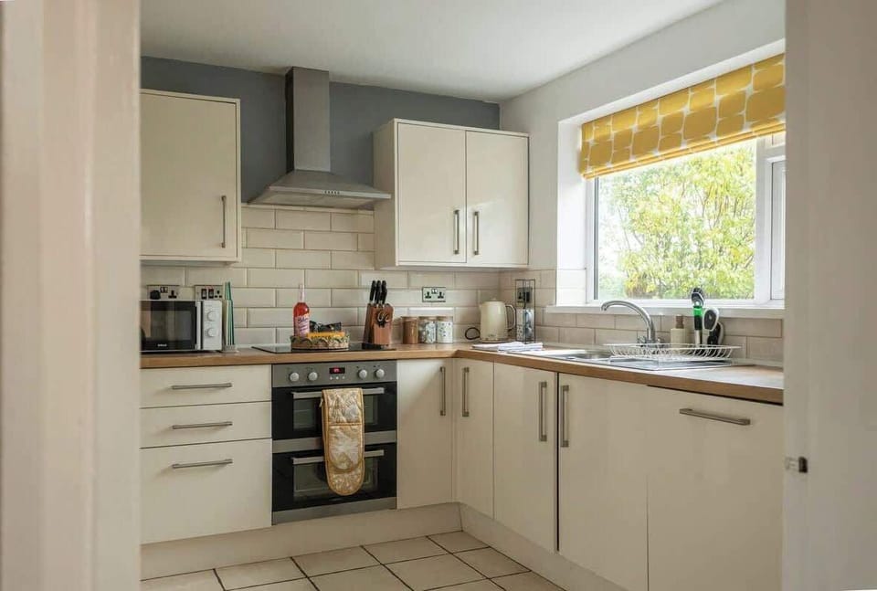 “Cook with ease in this clean, spacious kitchen — fully equipped for all your needs.”