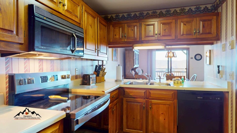 Kitchen with oven/stove, microwave, and dishwasher