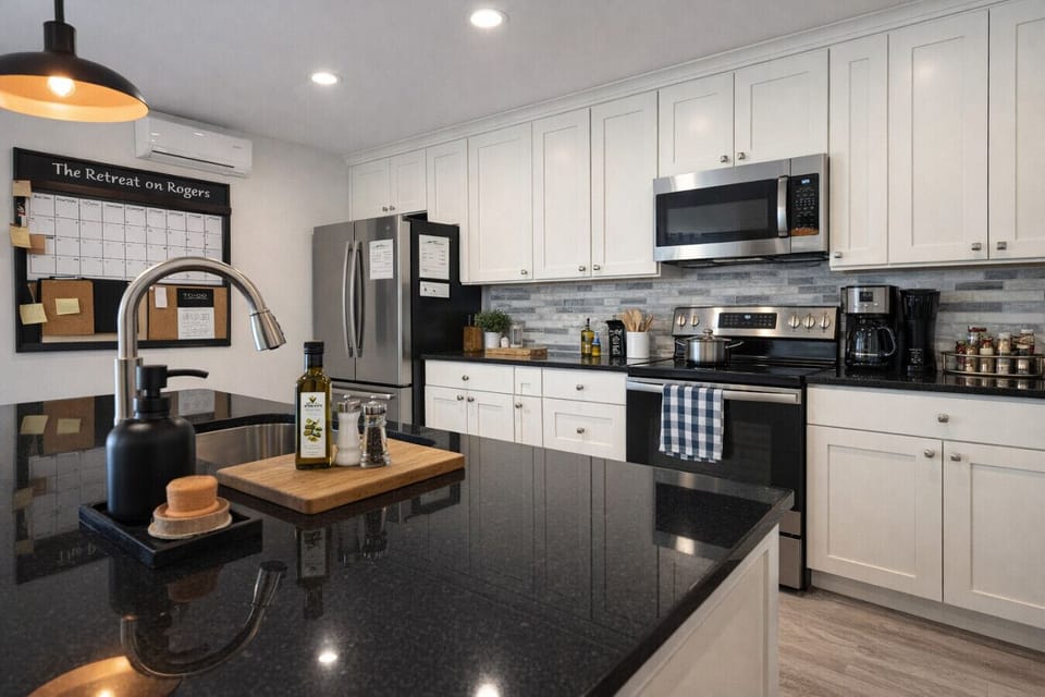 This bright and efficient kitchen is a real highlight for longer stays, giving you the freedom to cook like you’re at home. You’ll appreciate the expansive black granite island with its deep sink and modern fixtures, plus the full lineup of stainless stee