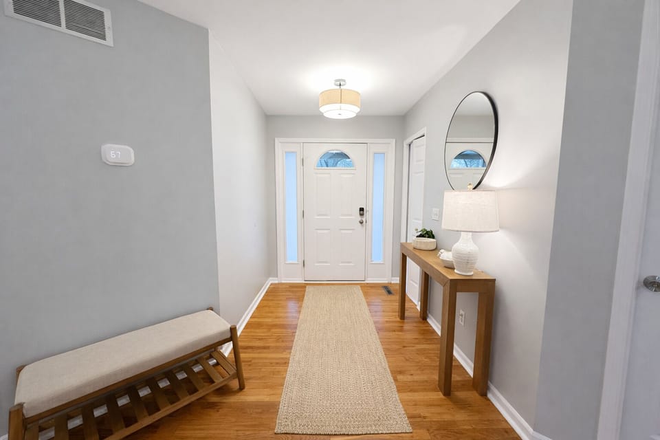 Bright entryway with storage bench and welcoming lakehouse charm