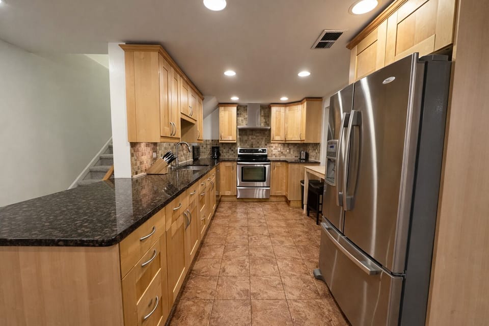 Fully equipped kitchen with stainless appliances and granite countertops
