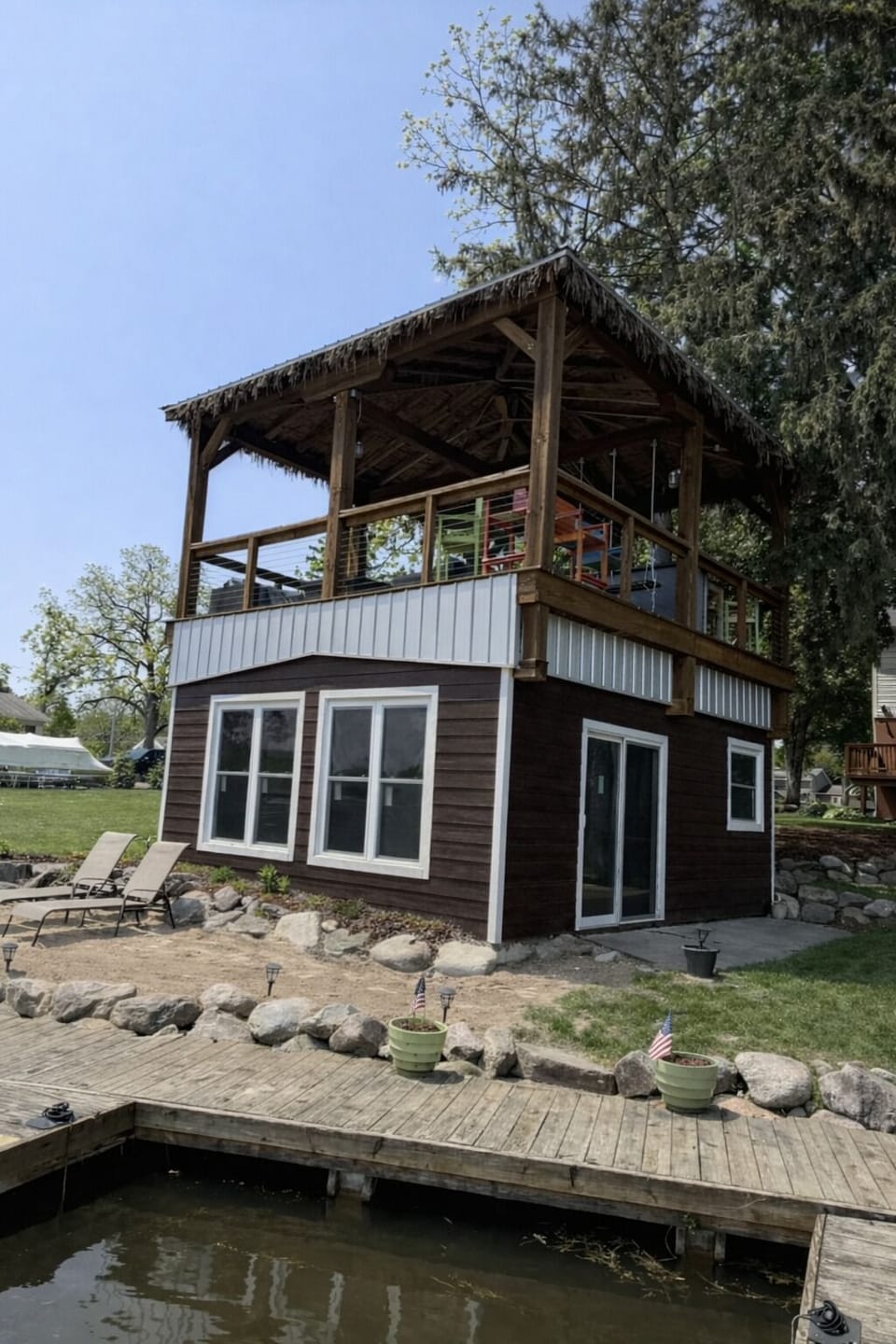 Lakefront exterior with elevated deck and private shoreline access
