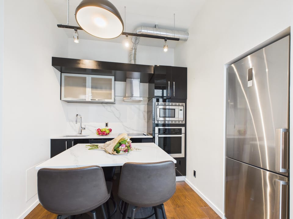 Kitchen island setup featuring built-in oven, range cooktop, and counter seating for casual meals.