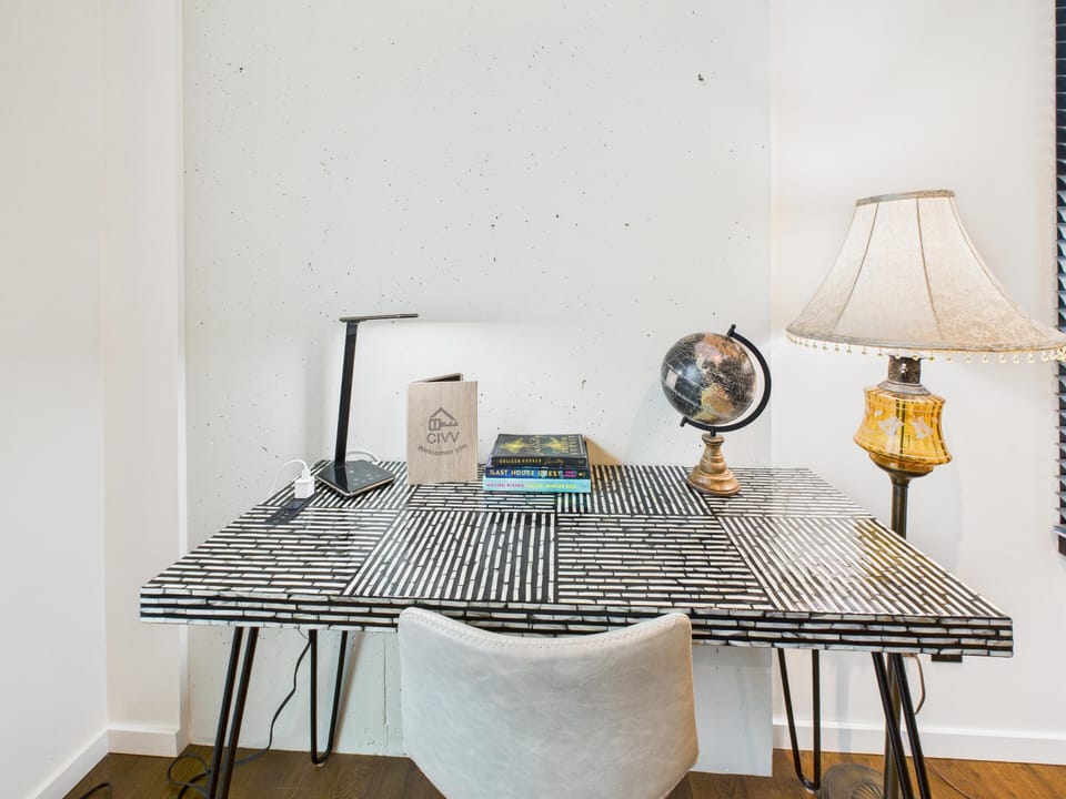 Dedicated workstation featuring a desk, lamp, and seating setup—ideal for remote work or studying.