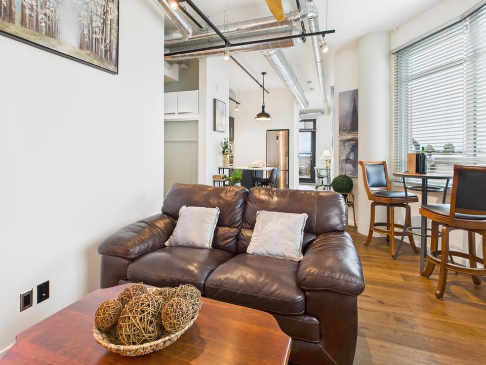 Open-concept floor plan seamlessly integrating the main living room, kitchen island, and window dining spot.