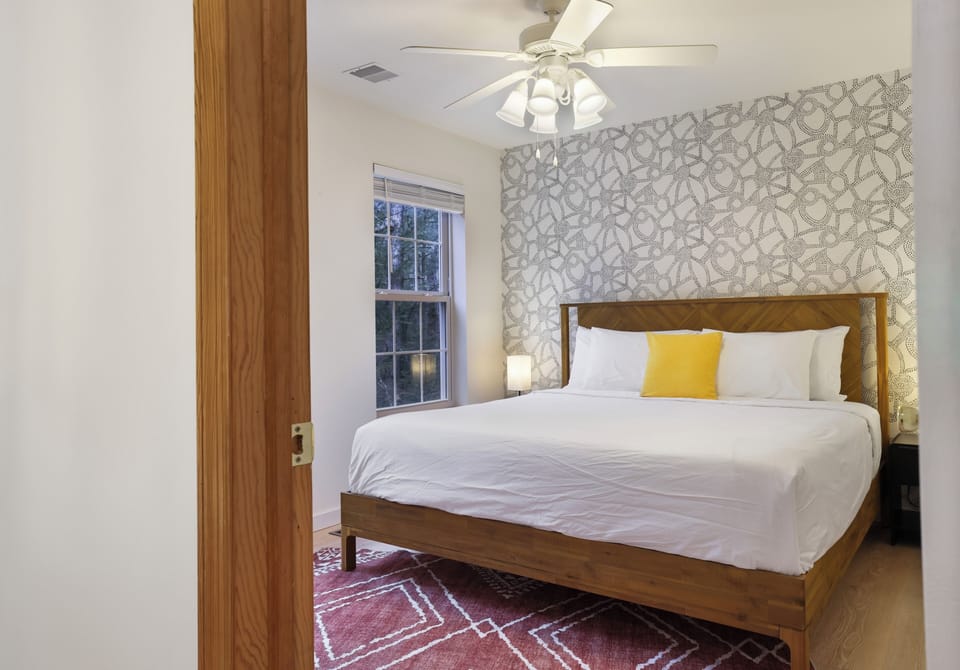 This bright and inviting 4th BR is cozy and offers a closet and smart TV.