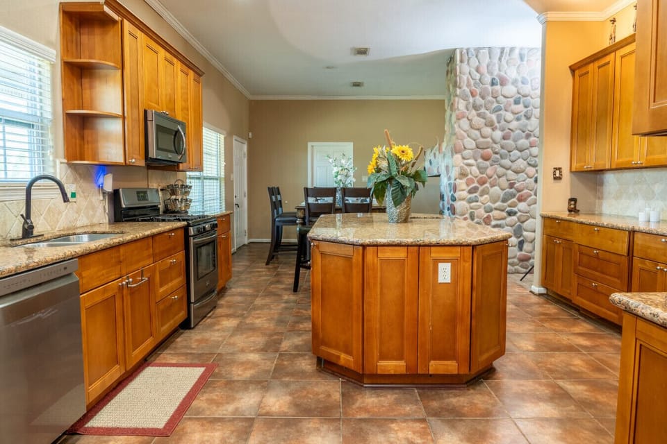 Kitchen | Spacious island with seating, granite counters, and modern stainless steel appliances
