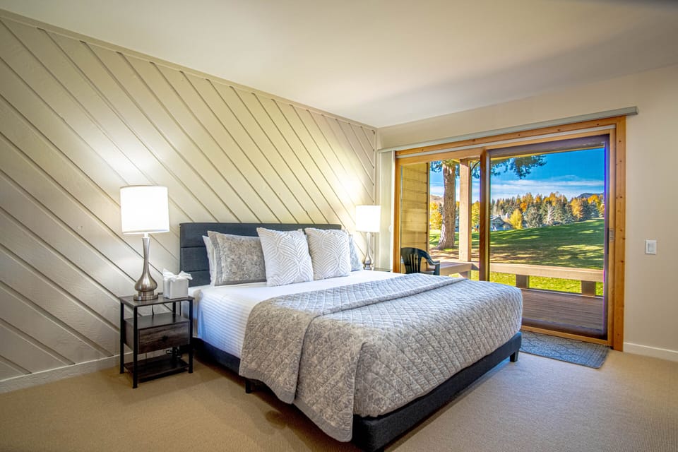 Retreat to the spacious master bedroom with a luxurious king bed and step out onto the private deck to enjoy breathtaking views of the Elkhorn Golf Course and surrounding mountains.